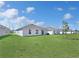 Manicured backyard lawn featuring a small shade tree at 1649 Teagan Ln, Winter Haven, FL 33884