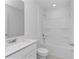 Modern bathroom featuring a sleek vanity, toilet, and a bathtub/shower combo at 1649 Teagan Ln, Winter Haven, FL 33884