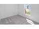 Bright bedroom featuring neutral carpet, white walls, and a window offering natural light at 1649 Teagan Ln, Winter Haven, FL 33884