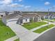 Aerial view of neighborhood homes, showing well-maintained lawns, concrete driveways and sidewalks at 1649 Teagan Ln, Winter Haven, FL 33884