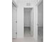 Hallway leading to a bedroom, featuring neutral walls and carpet at 1649 Teagan Ln, Winter Haven, FL 33884