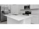 Close up of modern kitchen with stainless appliances and quartz countertops at 1649 Teagan Ln, Winter Haven, FL 33884
