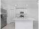 Kitchen featuring stainless appliances, white cabinets, and center island at 1649 Teagan Ln, Winter Haven, FL 33884