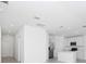 Open kitchen features stainless steel appliances, white cabinets, and modern lighting at 1649 Teagan Ln, Winter Haven, FL 33884