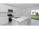 Bright kitchen with stainless steel appliances and an island overlooking backyard at 1649 Teagan Ln, Winter Haven, FL 33884