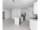 Open kitchen with stainless appliances, white cabinets, and a large center island at 1649 Teagan Ln, Winter Haven, FL 33884