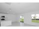 Bright, white kitchen featuring stainless steel appliances and sliding glass doors to the backyard at 1649 Teagan Ln, Winter Haven, FL 33884