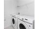 Well-lit laundry room featuring a side-by-side washer and dryer at 1649 Teagan Ln, Winter Haven, FL 33884