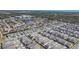 Expansive aerial view of a meticulously planned community with lush landscaping, a central lake, and well-maintained homes at 18851 Rawson St, Orlando, FL 32827
