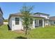 A view of the property's backyard and a covered patio, perfect for enjoying the outdoors at 1900 Archer Dr, Minneola, FL 34715