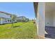 Manicured backyard with healthy green grass and neighboring homes at 1900 Archer Dr, Minneola, FL 34715
