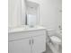 Bathroom featuring white cabinets, a light countertop, and a built-in toilet at 1900 Archer Dr, Minneola, FL 34715