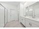A modern bathroom with double sinks, white cabinets, and a glass-enclosed shower at 1900 Archer Dr, Minneola, FL 34715
