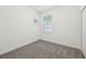 Bedroom showcasing neutral carpet, white trim, a closet, and a window at 1900 Archer Dr, Minneola, FL 34715