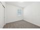Bright bedroom featuring neutral carpet, a window, and a closet at 1900 Archer Dr, Minneola, FL 34715