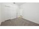 Bedroom featuring neutral carpet, a closet, and white trim at 1900 Archer Dr, Minneola, FL 34715