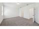 Spacious bedroom with carpet flooring and a view to bathroom and closet at 1900 Archer Dr, Minneola, FL 34715