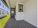 Inviting covered entrance with a glass paneled door and decorative gray trim at 1900 Archer Dr, Minneola, FL 34715