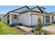 Beautifully landscaped front exterior featuring a paver driveway and walkway at 1900 Archer Dr, Minneola, FL 34715