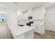 A modern kitchen with white cabinets, stainless steel appliances, and a large island at 1900 Archer Dr, Minneola, FL 34715