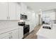 A bright kitchen features white cabinets, stainless steel appliances, and a white countertop at 1900 Archer Dr, Minneola, FL 34715
