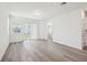 Spacious living area with sliding glass doors and contemporary wood-look floors at 1900 Archer Dr, Minneola, FL 34715