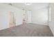 A spacious primary bedroom with carpet flooring and neutral paint at 1900 Archer Dr, Minneola, FL 34715