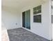Outdoor patio with sliding glass door and large window at 1900 Archer Dr, Minneola, FL 34715