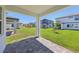 Covered patio with brick pavers, and a view of backyard and neighborhood at 1900 Archer Dr, Minneola, FL 34715
