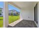 Spacious outdoor patio with view of lush backyard and neighboring homes at 1900 Archer Dr, Minneola, FL 34715