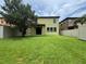 Large backyard with green grass, mature shade tree, and privacy fence at 191 Chickasaw Berry Rd, Ocoee, FL 34761