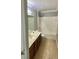 Bathroom with a single vanity, mirror, and toilet next to a shower and bath at 191 Chickasaw Berry Rd, Ocoee, FL 34761