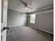 Spacious bedroom with gray carpet, gray walls, crown molding, and a bright window at 191 Chickasaw Berry Rd, Ocoee, FL 34761