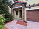 Charming front entrance with stone accents, covered porch, and two-car garage at 191 Chickasaw Berry Rd, Ocoee, FL 34761