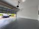 Two car garage with epoxy flooring. Electric car in driveway at 191 Chickasaw Berry Rd, Ocoee, FL 34761