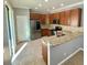 Modern kitchen with stainless steel appliances, granite countertops, and wood cabinets at 191 Chickasaw Berry Rd, Ocoee, FL 34761