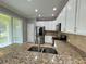 Bright kitchen featuring stainless steel appliances, granite countertops, and white cabinets at 191 Chickasaw Berry Rd, Ocoee, FL 34761