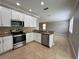 Updated kitchen featuring stainless appliances, granite countertops, and white cabinets at 191 Chickasaw Berry Rd, Ocoee, FL 34761