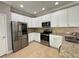 Updated kitchen features stainless steel appliances, granite counters and white cabinetry at 191 Chickasaw Berry Rd, Ocoee, FL 34761