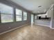 Open-concept living space featuring tile flooring, natural light, and kitchen view at 191 Chickasaw Berry Rd, Ocoee, FL 34761