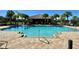 Enjoy the community pool surrounded by lounge chairs and palm trees at 191 Chickasaw Berry Rd, Ocoee, FL 34761