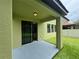 View of the covered porch and green backyard at 191 Chickasaw Berry Rd, Ocoee, FL 34761