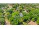 Overhead view of a house with a pool, surrounded by mature trees, illustrating its secluded and tranquil environment at 20 Stone Gate S, Longwood, FL 32779