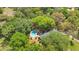 A private backyard oasis featuring a beautiful pool and mature landscaping surrounding the home at 20 Stone Gate S, Longwood, FL 32779