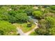 Aerial view of a home with a pool, surrounded by lush greenery, showcasing its private and secluded location at 20 Stone Gate S, Longwood, FL 32779