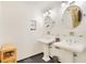 Modern bathroom featuring dual sinks, round mirrors, and a dark tile floor at 20 Stone Gate S, Longwood, FL 32779