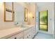 Classic bathroom with light blue accents, vanity storage, and natural light from the window at 20 Stone Gate S, Longwood, FL 32779