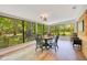 Dining area with wood floors, views of the backyard, and seating for four, creating a peaceful and inviting space at 20 Stone Gate S, Longwood, FL 32779