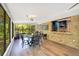 Charming dining area featuring wood floors, a table for four, and windows overlooking the backyard and greenery at 20 Stone Gate S, Longwood, FL 32779