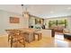 Open-concept dining area with wood table, stylish lighting, and views into the connected living space at 20 Stone Gate S, Longwood, FL 32779